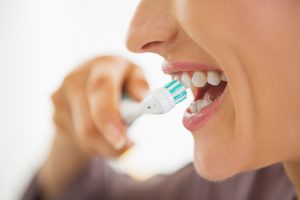 Close-up of a woman brushing her teeth