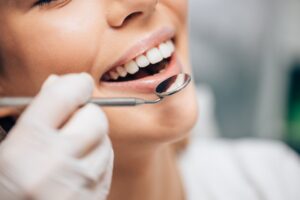 A woman having her teeth be examined